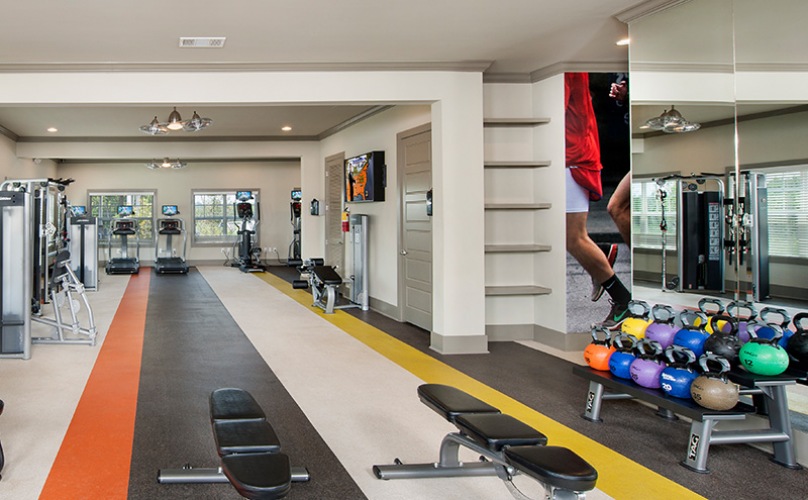 fitness center with equipment, treadmills and spacious areas