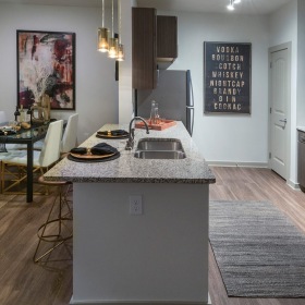 model kitchen with an island and easy access to the living room
